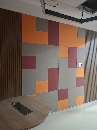 Custom orange, grey and burgundy acoustic panels in an office meeting area