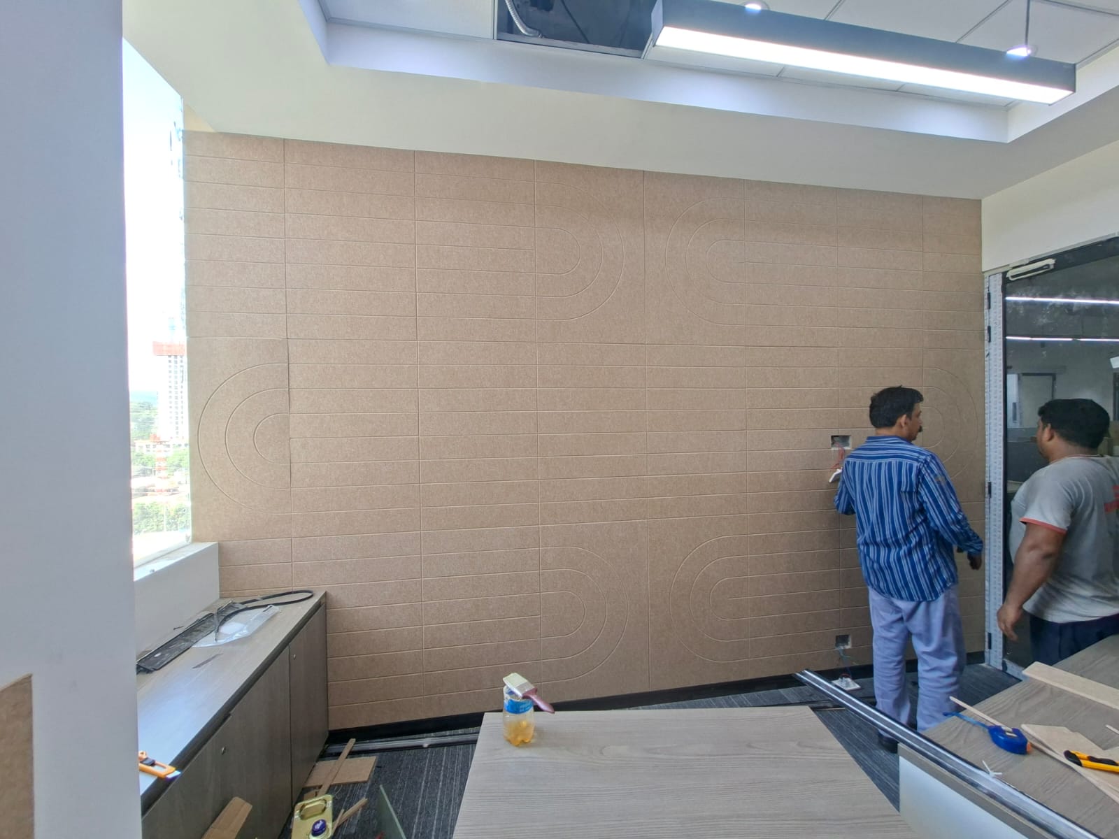 Acoustic wall panel installation in progress