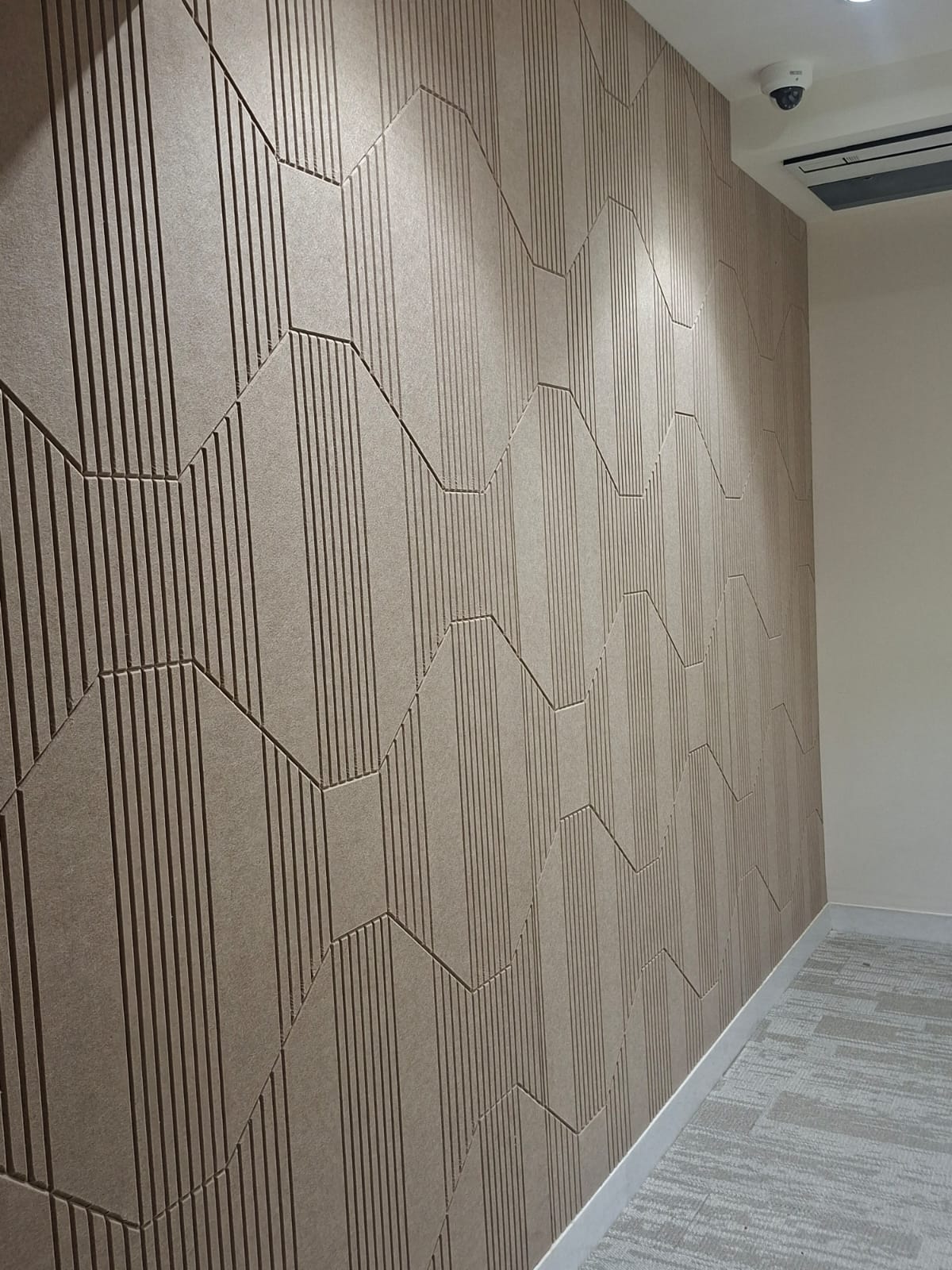 Close view of a textured geometric acoustic wall treatment