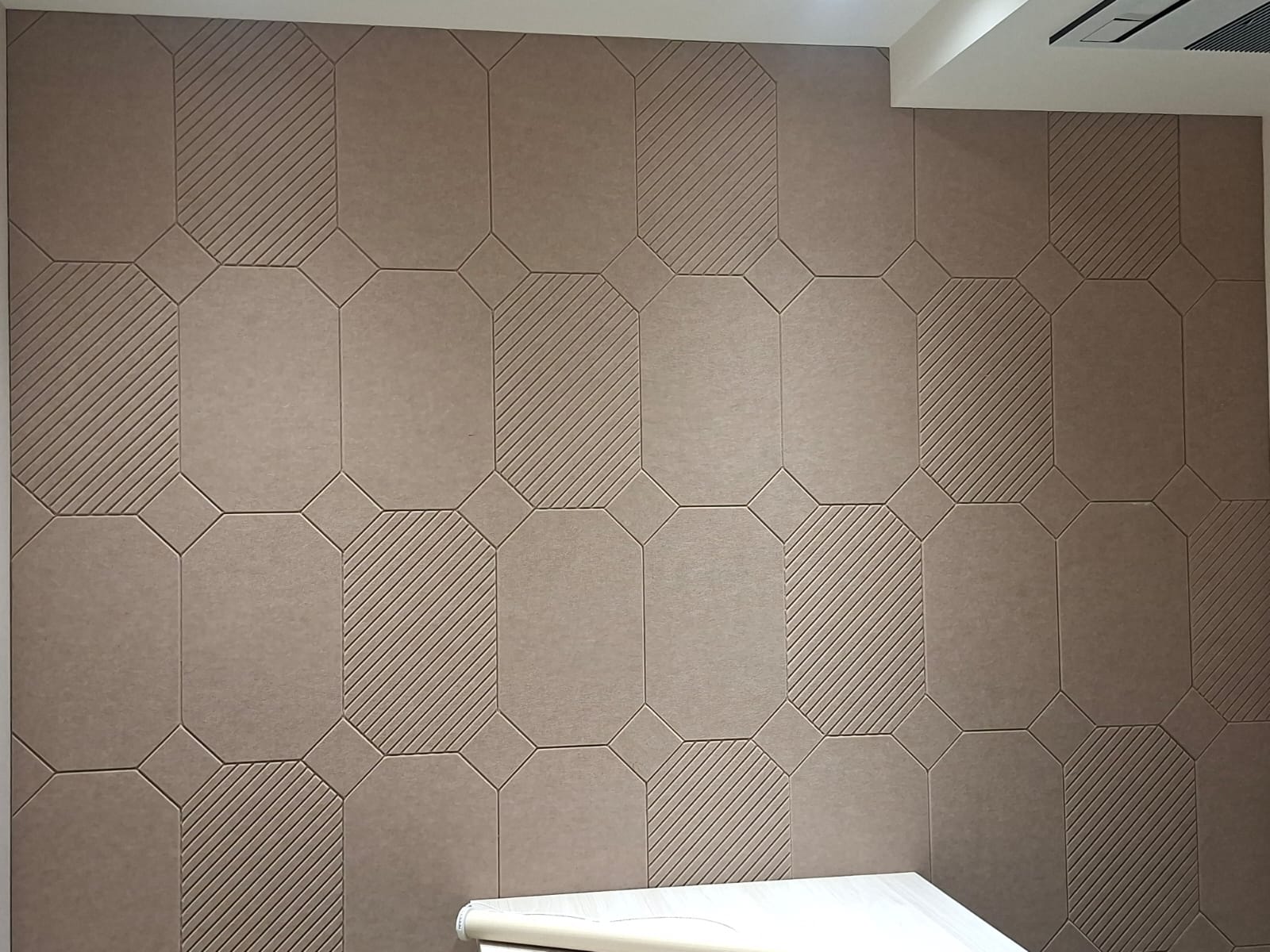 Finished geometric acoustic wall panels in a meeting room